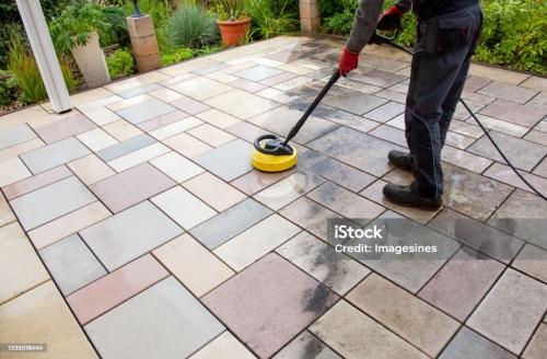Person worker cleaning the outdoors floor.